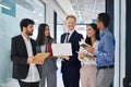 Happy diverse professional team young business people talking in office hallway. Royalty Free Stock Photo