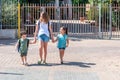 Happy school children going to home after school outdoor at sunny autumn day.