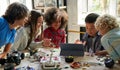 Happy diverse school children students building robotic cars using computer. Royalty Free Stock Photo