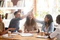 Happy diverse students or employees giving high five, celebrating success Royalty Free Stock Photo