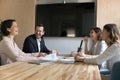 Diverse workmates joking and laughing gather in conference room Royalty Free Stock Photo