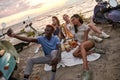 Happy diverse young people smiling while taking selfie, having picnic, spending time together on the beach Royalty Free Stock Photo