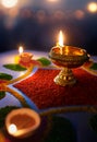 Diya lamps lit on colorful rangoli against blurred bokeh light background