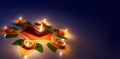 Diya oil lamps lit on colorful rangoli with copy space Royalty Free Stock Photo