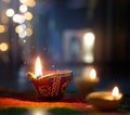 Lit diya lamp on street at night with shallow depth of field background Royalty Free Stock Photo