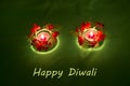 Happy Diwali. Traditional Indian festival green background with burning candles decorated with bright red flowers. Deepavali celeb