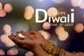 Happy Diwali - Woman hands with henna holding lit candle isolated on dark background. Clay Diya lamps lit during Dipavali, Hindu Royalty Free Stock Photo