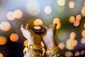 Happy Diwali - Woman hands with henna holding lit candle isolated on dark background. Clay Diya lamps lit during Dipavali, Hindu Royalty Free Stock Photo