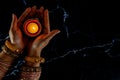 Happy Diwali - Woman hands with henna holding lit candle isolated on dark background Royalty Free Stock Photo