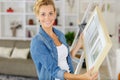 Happy diy woman renewing frame at home Royalty Free Stock Photo