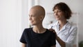 Happy doctor and female cancer patient hope for recovery