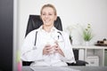 Happy Doctor on her Chair with a Cup of Coffee Royalty Free Stock Photo