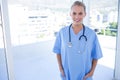 happy doctor looking at camera with hands in pockets Royalty Free Stock Photo