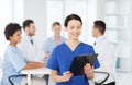 Happy doctor over group of medics at hospital Royalty Free Stock Photo