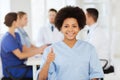 Happy doctor over group of medics at hospital Royalty Free Stock Photo