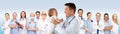 Happy doctor or pediatrician with baby over blue Royalty Free Stock Photo