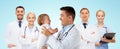 Happy doctor or pediatrician with baby over blue Royalty Free Stock Photo