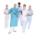 Happy doctor in surgical gown with his coworkers