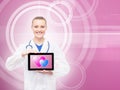 Happy doctor with a tablet and hearts on it Royalty Free Stock Photo