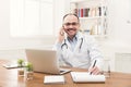 Happy doctor talking on phone with his patient Royalty Free Stock Photo