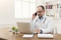 Happy doctor talking on phone with his patient Royalty Free Stock Photo