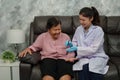 happy doctor using glucometer checking blood sugar level of senior woman. diabetes concept. good result Royalty Free Stock Photo