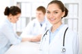 Happy doctor woman with medical staff at the hospital sitting at the table Royalty Free Stock Photo