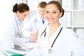 Happy doctor woman with medical staff at the hospital sitting at the table Royalty Free Stock Photo