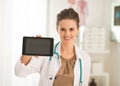 Happy doctor woman showing tablet pc blank screen Royalty Free Stock Photo