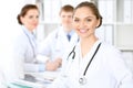 Happy doctor woman with medical staff at the hospital sitting at the table Royalty Free Stock Photo