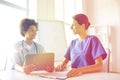 Happy doctors with tablet pc meeting at hospital Royalty Free Stock Photo