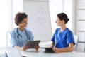 Happy doctors with tablet pc meeting at hospital Royalty Free Stock Photo