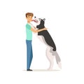 Happy dog licking man s face. Guy having fun with Siberian Husky. Doggy meets owner after long time. Domestic animal