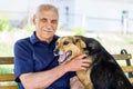 Happy dog pressed against his master. Dog shows his love for owner while resting in park Royalty Free Stock Photo