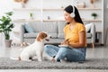 Happy dog sitting by its cheerful female owner Royalty Free Stock Photo