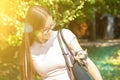 Happy dog smiles with his eyes closed,the puppy looks out of the bag, walks with the owner Royalty Free Stock Photo