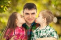 Happy doughter and son kissing their father Royalty Free Stock Photo