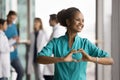 Happy dreamy beautiful African doctor woman promoting cardio healthcare checkup Royalty Free Stock Photo