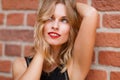 Happy dreamy blond woman with red lipstick and sensual smile