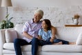 Happy dreamy grandfather and grandson kid sitting, relaxing on couch Royalty Free Stock Photo