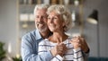 Happy dreamy older mature spouses visualizing future together. Royalty Free Stock Photo