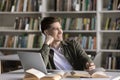 Happy dreamy student guy working on scientific article