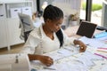 Happy dressmaker designer working in workshop studio