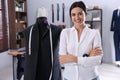 Happy dressmaker near mannequin with unfinished garment and measuring tape in workshop Royalty Free Stock Photo