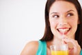 Happy, drinking and face of woman with juice for nutrition, wellness and hydration in studio. Beverage, smile and