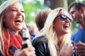 Happy, drinks and women at music festival, concert or party laughing, excited and enjoy outdoor rave or techno Royalty Free Stock Photo