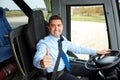 Happy driver driving bus and snowing thumbs up
