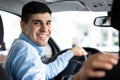 Happy Young Man Sitting In Auto In Dealership Center Royalty Free Stock Photo