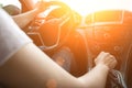 Happy driver inside car at sunset. Young woman have fun ride trip travel on road in summer sunny day. Drive vacation concept Royalty Free Stock Photo