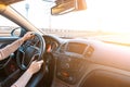 Happy driver inside car at sunset. Young woman have fun ride trip travel on road in winter sunny day. Drive vacation concept Royalty Free Stock Photo